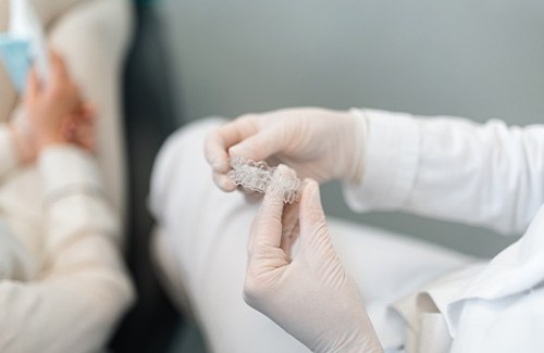 Dentist in Grantsville showing Invisalign aligners