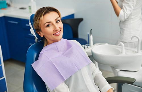 Woman smiling while sitting in treatment chair